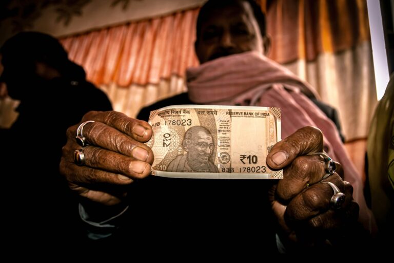 person holding 5 us dollar bill