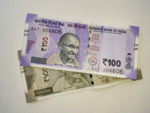 two indian currency bills laying on top of each other