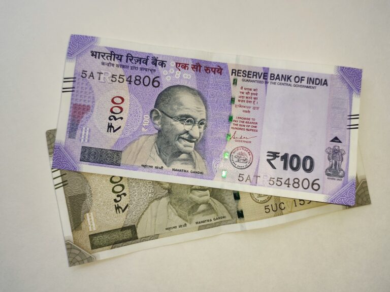 two indian currency bills laying on top of each other